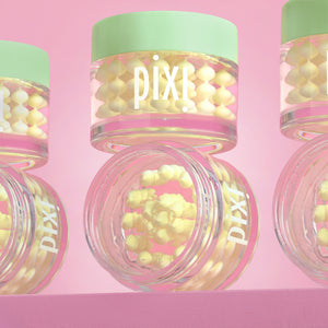 Pixi Vitamin-C CreamSerum product with pink lid and green cap on a pink background - several jars in view